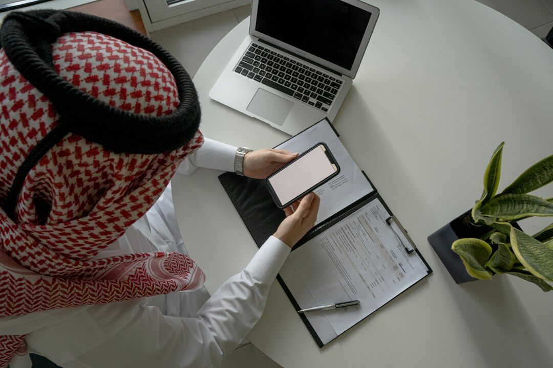 Business professional analyzing reports on a laptop